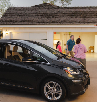 Family in front of house with their EV